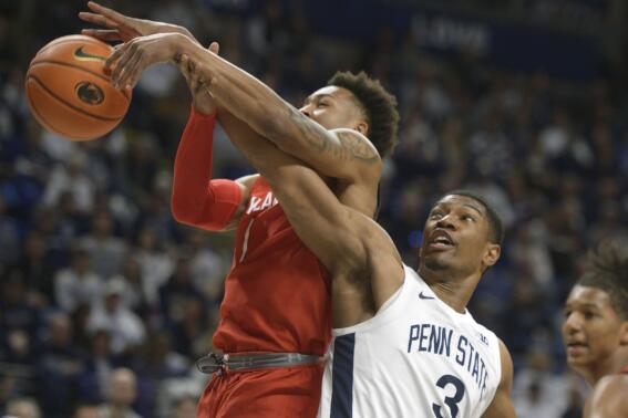 Maryland's Jahmir Young,left, and Penn State's Kebba Njie (3) battle for a rebound during the first half of an NCAA college basketball game, Sunday, March 5, 2023, in State College, Pa. (AP Photo/Gary M. Baranec)