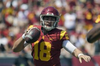 FILE - In this Sept. 1, 2018, file photo, then-Southern California quarterback Jt Daniels scrambles with the ball during the first half of an NCAA college football game against UNLV in Los Angeles. Two transfers, Jamie Newman, from Wake Forest, and JT Daniels, from Southern Cal, are names to watch in Georgia’s five-player quarterback competition. Newman may be the favorite as practice started Monday because Daniels is still recovering from a knee injury at USC. (AP Photo/Mark J. Terrill, File)