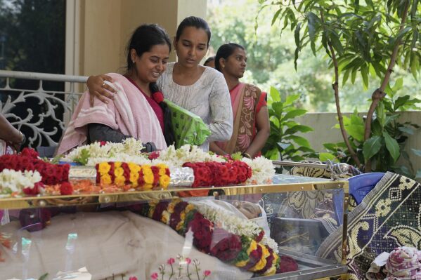 A relative cries next to the body of 14-year-old Divyanshi Shivakumar, who lost her life in Wednesday's deadly stampede during celebrations outside a stadium for Royal Challengers Bengaluru, winners of the Indian Premier League, at her residence ahead of her last rites in Bengaluru, India, Thursday, June 5, 2025. (AP Photo/Aijaz Rahi)