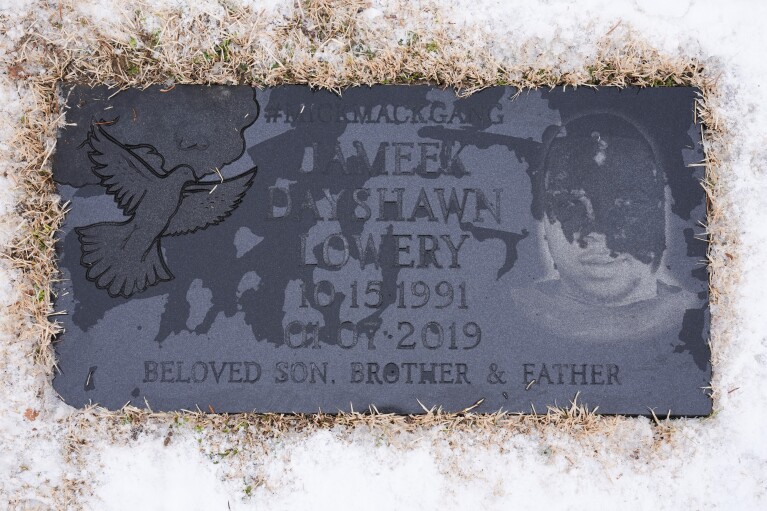 The tombstone of Jameek Lowery is seen as friends and family visit in Garfield, N.J. (AP Photo/Seth Wenig)