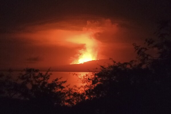 In this photo released by Galapagos National, La Cumbre volcano erupts at Fernandina Island, in Galápagos Islands, Ecuador. Sunday, March 3, 2024. (Galapagos National Park via AP)