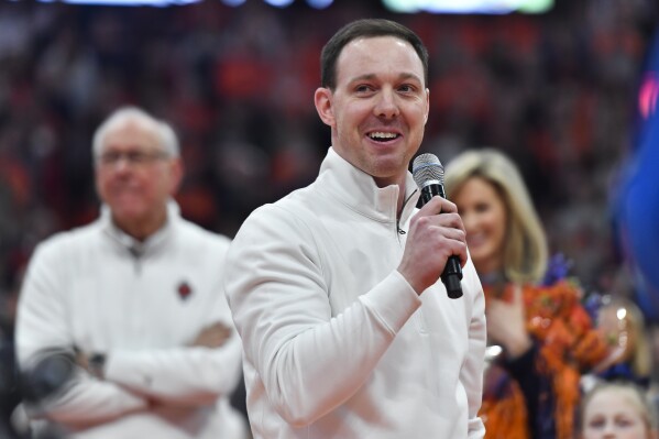 FILE - Syracuse assistant coach Gerry McNamara gives remarks at his jersey retirement ceremony after an NCAA college basketball game against Wake Forest in Syracuse, N.Y., Saturday, March 4, 2023. Gerry McNamara has signed a deal to take over as coach at Siena, deciding to leave Syracuse after two decades as a standout player, assistant and eventually ascending to associate head coach for the Orange. McNamara's signing was announced by Siena on Friday, March 29, 2024, and makes him a collegiate head coach for the first time. (AP Photo/Adrian Kraus, File)