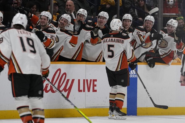 Anaheim Ducks defenseman Urho Vaakanainen (5) is congratulated by teammates after a goal against the Nashville Predators during the third period of an NHL hockey game Tuesday, Nov. 14, 2023, in Nashville, Tenn. (AP Photo/George Walker IV)