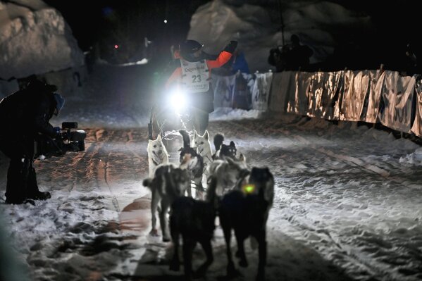 Dallas Seavey's team runs into the chute near the finish line of the Iditarod Trail Sled Dog Race race near Willow, Alaska, early Monday, March 15, 2021. Seavey has won the Iditarod and matched a milestone in the world's most famous sled dog race. It's the fifth title for the 34-year-old Seavey, matching the record of most wins by any musher. (Marc Lester/Anchorage Daily News via AP, Pool)