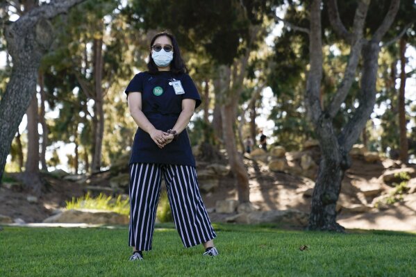 Katie Doan, a former Whole Foods employee, poses for a photo Thursday, July 16, 2020, in Costa Mesa, Calif. Doan started tracking COVID-19 cases at Amazon-owned Whole Foods in April. (AP Photo/Ashley Landis)