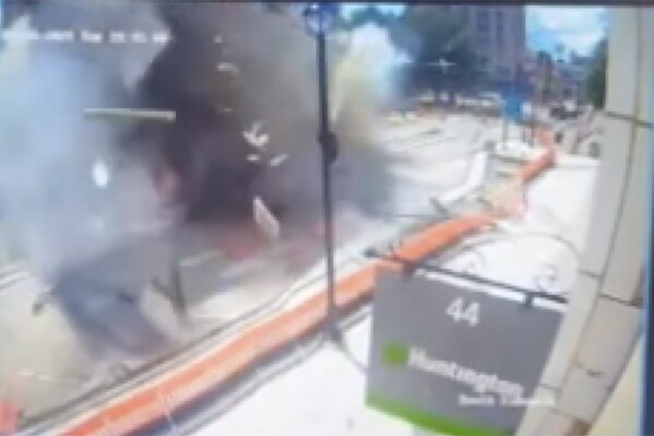 This image made from video provided by Cleveland 19 WOIO-TV shows debris flying through the air after a natural gas explosion caused extensive damage to a building in Youngstown, Ohio, Tuesday, May 28, 2024, and injured people, authorities said. (WOIO-TV via AP)