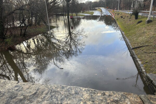 Storm water floods the Bronx River Parkway, in Yonkers, NY, Monday, Dec. 18, 2023. Heavy rain and high winds swept through the Northeast on Monday for the second time in a week, spurring flood warnings, electricity outages, flight cancelations and school closings. (AP Photo/Luke Sheridan)