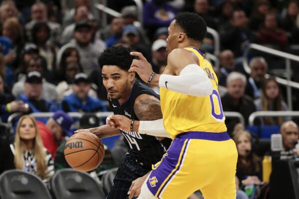 Orlando Magic guard Gary Harris (14) drives against Los Angeles Lakers guard Russell Westbrook (0) during the first half of an NBA basketball game, Tuesday, Dec. 27, 2022, in Orlando, Fla. (AP Photo/Kevin Kolczynski)