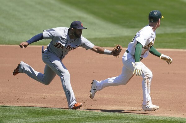 Oakland Athletics' Ramon Laureano, left, is tagged out by Houston