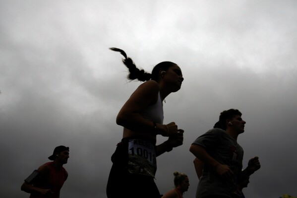 Runners compete in the Falmouth Road Race, Sunday, Aug. 18, 2024, in Falmouth, Mass. (AP Photo/Jeff Roberson)