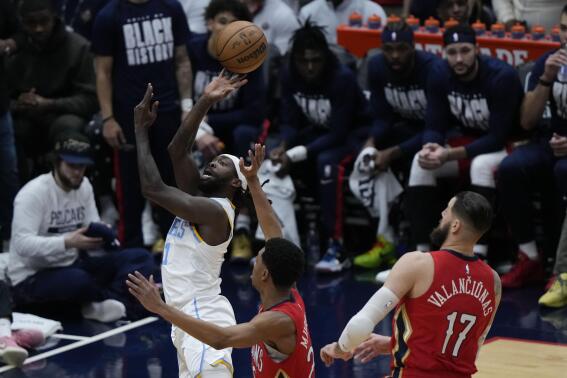 Los Angeles Lakers guard Patrick Beverley (21) goes to the basket over New Orleans Pelicans guard Trey Murphy III and center Jonas Valanciunas (17) in the first half of an NBA basketball game in New Orleans, Saturday, Feb. 4, 2023. (AP Photo/Gerald Herbert)
