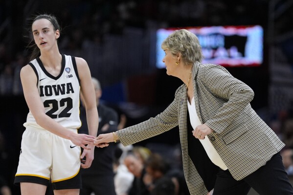 Iowa guard Caitlin Clark (22) reacts with head coach Lisa Bluder during the second half of a Final Four college basketball game against UConn in the women's NCAA Tournament, Friday, April 5, 2024, in Cleveland. (AP Photo/Morry Gash)