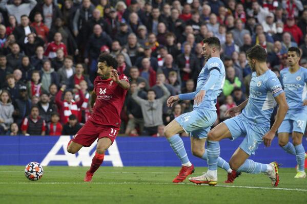 Liverpool's Mohamed Salah scores their side's second goal, during the English Premier League soccer match between Liverpool and Manchester City at Anfield, Liverpool, England, Sunday Oct. 3, 2021. (Peter Byrne/PA via AP)