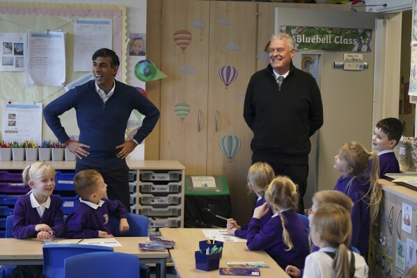 FILE - Britain's Prime Minister Rishi Sunak and Member of Parliament for Ashfield Lee Anderson visit a class at Woodland View Primary School, in Sutton-in-Ashfield, Nottinghamshire, England, Thursday, Jan. 4, 2024. The U.K.’s governing Conservative Party has suspended ties with one if its lawmakers after he accused London Mayor Sadiq Khan of being controlled by Islamists, as tensions over the Israel-Hamas war continue to roil British politics. (Jacob King/Pool Photo via AP, File)