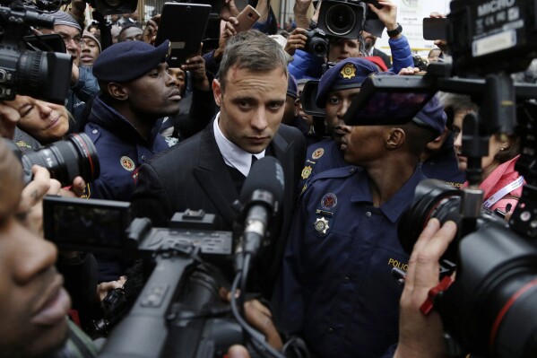 FILE - Oscar Pistorius leaves the High Court in Pretoria, South Africa, on June 14, 2016 during his trail for the murder of girlfriend Reeva Steenkamp. Oscar Pistorius is due on Friday, Jan. 5, 2024 to be released from prison on parole to live under strict conditions at a family home after serving nearly nine years of his murder sentence for the shooting death of girlfriend Reeva Steenkamp on Valentine’s Day 2013. (AP Photo/Themba Hadebe, File)