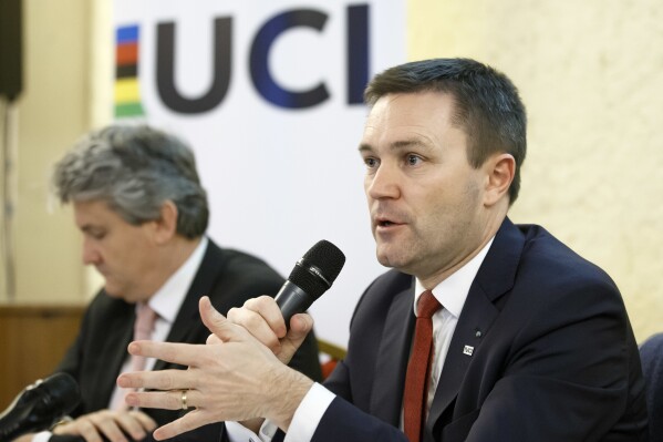 FILE - UCI President David Lappartient, right, speaks to the media about the fight against technological fraud during a press conference in Geneva, Switzerland, Wednesday, March 21, 2018. Female transgender athletes who transitioned after male puberty will no longer be able to compete in women's races, world cycling governing body the UCI said Friday, July 14, 2023. Despite the ban, Lappartient said “the UCI would like to reaffirm that cycling — as a competitive sport, leisure activity or means of transport — is open to everyone, including transgender people, whom we encourage like everyone else to take part in our sport."(Salvatore Di Nolfi/Keystone via AP, File)