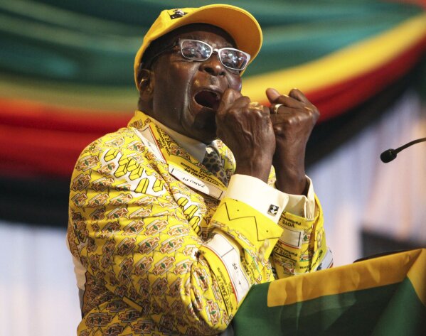 FILE - In this Friday, Dec. 7, 2012 file photo Zimbabwean President Robert Mugabe clenches his fists as he delivers his speech at his party's 13th annual conference, in Gweru about 250 Kilometres s...