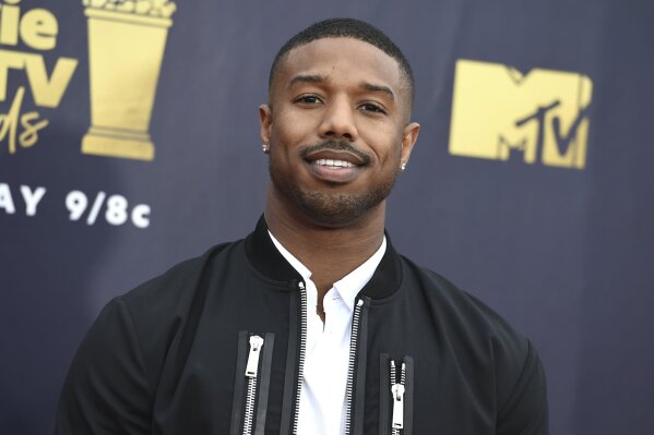 
              FILE - In this June 16, 2018 file photo, Michael B. Jordan arrives at the MTV Movie and TV Awards in Santa Monica, Calif. A half year after Frances McDormand introduced the world to the concept of an inclusion rider in her Oscars speech, Warner Bros. and its sister companies are announcing a company-wide commitment to diversity and inclusion. The first production to fall under the policy will be the Michael B. Jordan film “Just Mercy,” which begins shooting this week. Jordan was an early advocate of the idea of inclusion riders at his production company and helped craft the framework for WarnerMedia. (Photo by Jordan Strauss/Invision/AP, File)
            