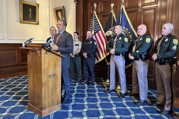 FILE - New Hampshire Gov. Chris Sununu announces details of a new Northern Border Alliance Task Force, Oct. 19, 2023, in Concord, N.H. Police in northern New Hampshire would be allowed to bring trespassing charges against people suspected of illegally entering the U.S. from Canada under a bill approved by the state Senate on Thursday, March 7, 2024. The legislation, which now goes to the House, was requested by Sununu, who created a a task force last year to patrol along the state’s border with Canada. (AP Photo/Holly Ramer, File)