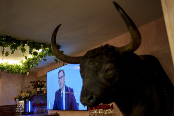 PP party leader Alberto Nunez Feijoo is displayed on a television screen in a bar during a live broadcast debate with Spanish Prime minister and PSOE candidate Pedro Sanchez ahead the general elections in Madrid, Spain, Monday, July 10, 2023. Sanchez called snap general elections for July 23 after the Socialist party and United We Can took a serious battering in local and regional elections May 28. (AP Photo/Manu Fernandez)