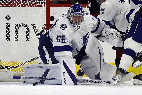 Tampa Bay Lightning goaltender Andrei Vasilevskiy (88) watches the puck during the first period of the team's NHL hockey game against the Carolina Hurricanes in Raleigh, N.C., Friday, Nov. 24, 2023. (AP Photo/Karl B DeBlaker)