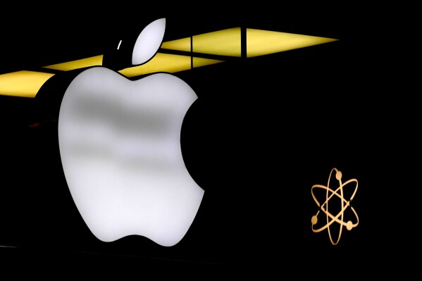 The Apple logo is illuminated at a store in Munich, Germany, Monday, Nov. 13, 2023. AP Photo/Matthias Schrader, File)(