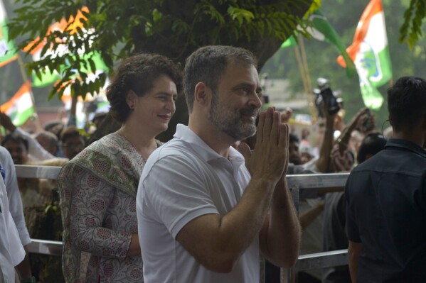 India's opposition Congress party leader Rahul Gandhi and his sister and party leader Priyanka Vadra, left, greets media personnel as they arrive at party headquarters in New Delhi, India, August 04, 2023. India's top court on Friday stayed the criminal defamation conviction of opposition leader Rahul Gandhi for mocking Prime Minister Narendra Modi's surname — a conviction that disqualified him from being a member of parliament. (AP Photo/Dinesh Joshi)