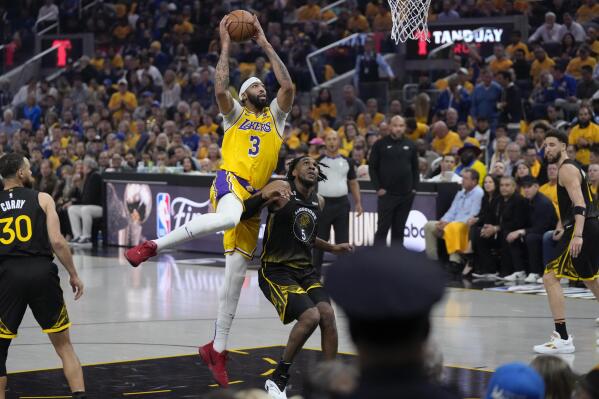 Los Angeles Lakers forward Anthony Davis (3) shoots while defended by Golden State Warriors forward Kevon Looney (5) during the first half of an NBA basketball Western Conference semifinal game, Tuesday, May 2, 2023, in San Francisco. (AP Photo/Jeff Chiu)