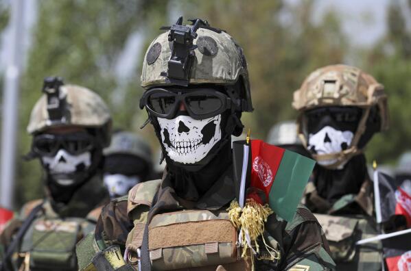 FILE - New Afghan Army special forces members attend their graduation ceremony after a three-month training program at the Kabul Military Training Center (KMTC) in Kabul, Afghanistan, Saturday, July 17, 2021. Afghan special forces soldiers who fought alongside American troops and then fled to Iran after the chaotic U.S. withdrawal last year are now being recruited by the Russian military to fight in Ukraine, three former Afghan generals told The Associated Press. (AP Photo/Rahmat Gul, File)
