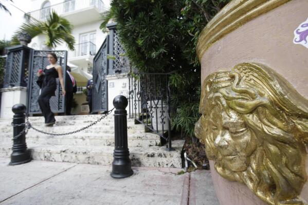 FILE - In this Sept. 17, 2013, file photo, the Versace logo is shown on a planter outside of the South Beach mansion that once belonged to Gianni Versace in Miami Beach, Fla. Two men apparently killed themselves, police said, Thursday, July 15, 2021, in a suite at the Miami Beach hotel that Gianni Versace turned into his mansion, nearly 24 years to the day before the fashion designer died on the building's front steps. Their bodies were found by housekeeping on Wednesday, the eve of the anniversary of Versace's slaying by a suspected serial killer.  (AP Photo/Wilfredo Lee)