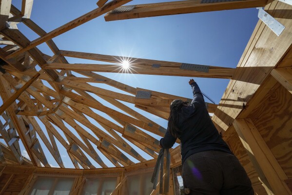 File - Workers build a home on Sept. 19, 2023, in Marshall, N.C. On Wednesday, Jan. 31, 2024, the Labor Department reports on wages and benefits for U.S. workers during the last quarter of 2023. (AP Photo/Chris Carlson, File)