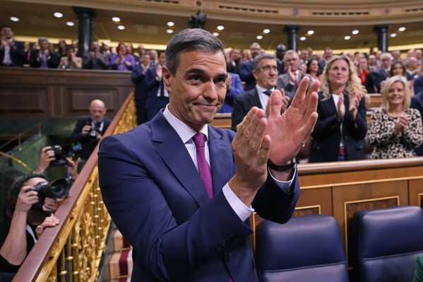 Spain's acting Prime Minister Pedro Sanchez applauds at the start of the investiture debate at the Spanish Parliament in Madrid, Spain, Wednesday, Nov. 15, 2023. Sanchez will defend his controversial amnesty deal for Catalonia's separatists in parliament as part of a debate a day before the Socialist leader seeks the endorsement of the chamber to form a new government. (AP Photo/Manu Fernandez)