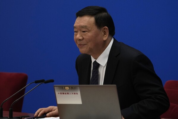 National People's Congress spokesperson Lou Qinjian attends a press conference on the eve of the National People's Congress at the Great Hall of the People in Beijing, Monday, March 4, 2024. (AP Photo/Ng Han Guan)