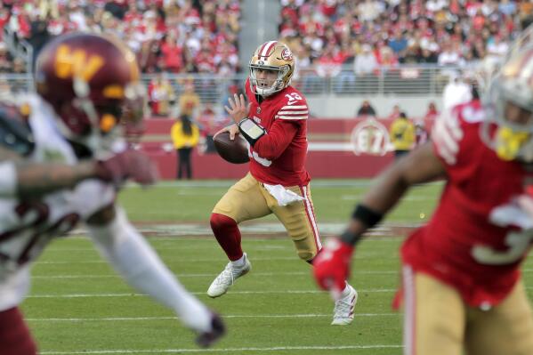 San Francisco 49ers quarterback Brock Purdy (13) scrambles in the second half of an NFL football game against the Washington Commanders in Santa Clara, Calif., Saturday, Dec. 24, 2022. (Carlos Avila Gonzalez/San Francisco Chronicle via AP)