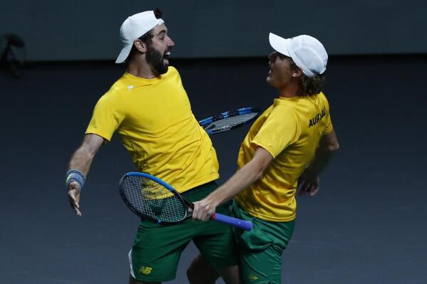 Australia's Jordan Thomson, left and Max Purcell celibate after defeating Croatia during the first semi-final Davis Cup tennis match between Australia and Croatia in Malaga, Spain, Friday, Nov. 25, 2022. (AP Photo/Joan Monfort)