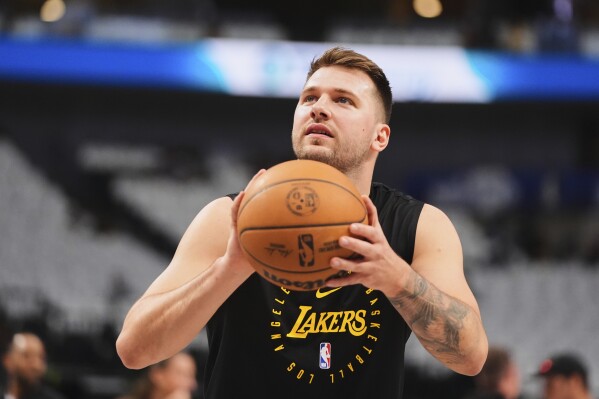 Los Angeles Lakers' Luka Doncic warms up before an NBA basketball game against the Dallas Mavericks in Dallas, Wednesday, April 9, 2025. (AP Photo/LM Otero)