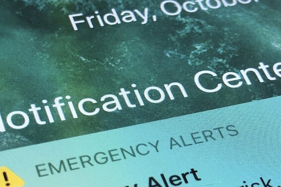 FILE - An emergency alert is displayed on a cellphone, Oct. 30, 2020, in Rio Rancho, N.M. (AP Photo/Susan Montoya Bryan, File)