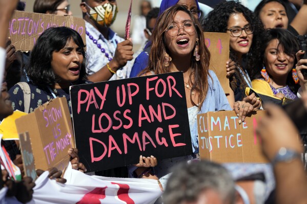 FILE - Mitzi Jonelle Tan, of the Philippines, center, participates in a Fridays for Future protest calling for money for climate action at the COP27 U.N. Climate Summit, Nov. 11, 2022, in Sharm el-Sheikh, Egypt. This year’s COP28 in Dubai is likely to see more discussion about compensation for developing nations harmed by climate change. (AP Photo/Peter Dejong, File)