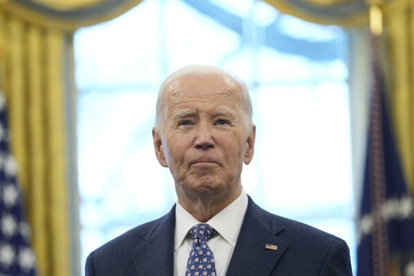President Joe Biden pauses during a photo opportunity with Medal of Valor recipients in the Oval Office of the White House in Washington, Jan. 3, 2025. (AP Photo/Susan Walsh, File)