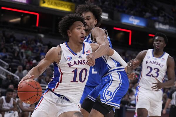 Kansas forward Jalen Wilson (10) drives around Duke guard Tyrese Proctor, center, during the second half of an NCAA college basketball game, Tuesday, Nov. 15, 2022, in Indianapolis. (AP Photo/Darron Cummings)
