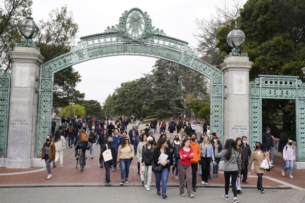 File - Students make their way through the Sather Gate near Sproul Plaza on the University of California, Berkeley, campus March 29, 2022, in Berkeley, Calif. The Free Application for Federal Student Aid is available for the 2024-2025 school year, three months later than usual. (Ǻ Photo/Eric Risberg, File)