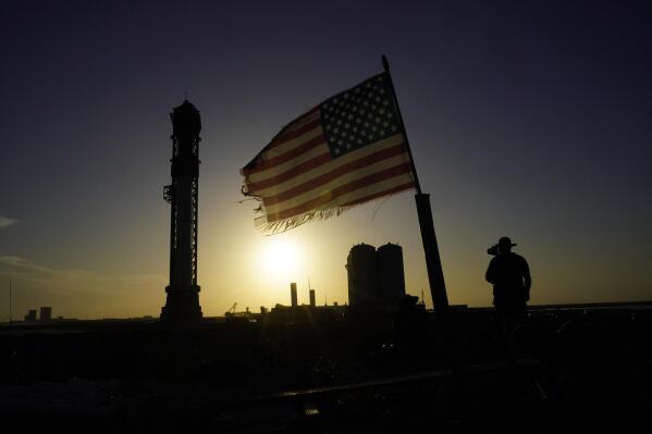 Onlookers watch as SpaceX's Starship, the world's biggest and most powerful rocket, stands ready for launch in Boca Chica, Texas, Sunday, April 16, 2023. The test launch is scheduled for Monday. (AP Photo/Eric Gay)