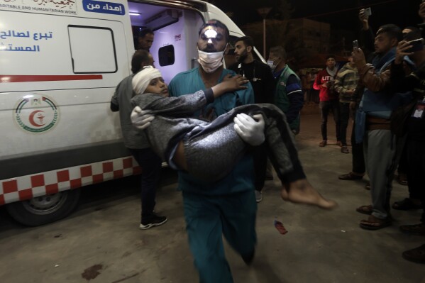A wounded Palestinian boy is carried into the Nasser Hospital following Israeli bombardment on Khan Younis refugee camp, southern Gaza Strip, Monday, Nov. 20, 2023. (AP Photo/Mohammed Dahman)
