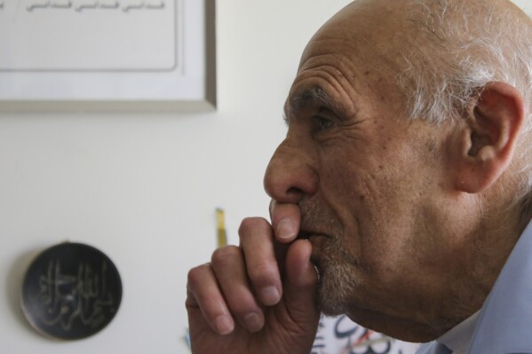Dawud Assad, 92, stands in front of Palestinian decor in his home in Monroe Township, N.J., on May 11, 2024. (AP Photo/Noreen Nasir)