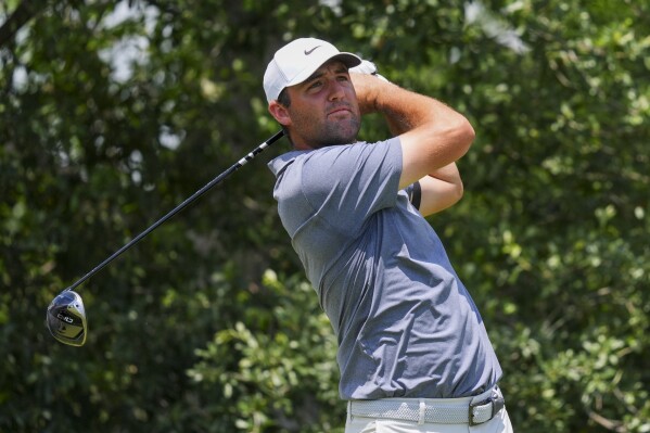 Scottie Scheffler watches his tee shot on the ninth hole during the final round of the Charles Schwab Challenge golf tournament at Colonial Country Club in Fort Worth, Texas, Sunday, May 25, 2025. (AP Photo/LM Otero)