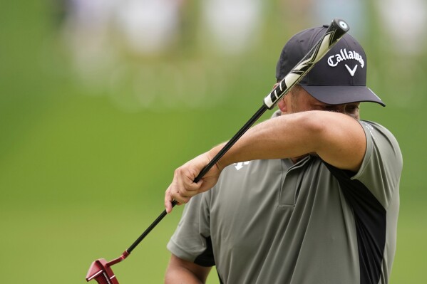 Xander Schauffele wipes his face on the sixth hole during the second round of the PGA Championship golf tournament at the Quail Hollow Club, Friday, May 16, 2025, in Charlotte, N.C. (AP Photo/David J. Phillip)