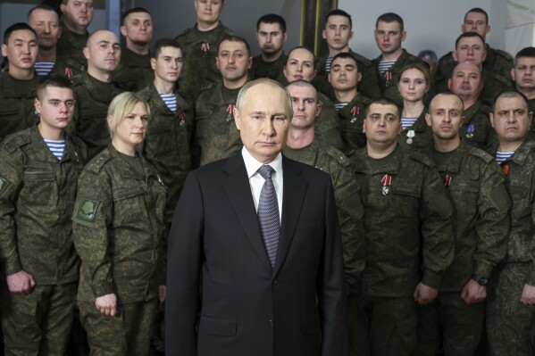 FILE - President Vladimir Putin speaks in his annual New Year's message after a visit to military officials at an unknown location in Russia, on Dec. 31, 2022. With the fighting in Ukraine entering its third year, Putin hopes to achieve his goals by biding his time and waiting for Western support for Ukraine to wither while Moscow maintains its steady military pressure along the front line. (Mikhail Klimentyev, Sputnik, Kremlin Pool Photo via AP, File)