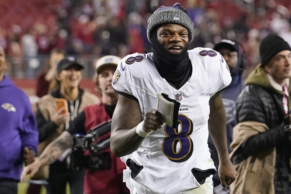 Baltimore Ravens quarterback Lamar Jackson (8) smiles as he runs off the field after the Ravens defeated the San Francisco 49ers in an NFL football game in Santa Clara, Calif., Monday, Dec. 25, 2023. (AP Photo/Godofredo A. Vásquez)