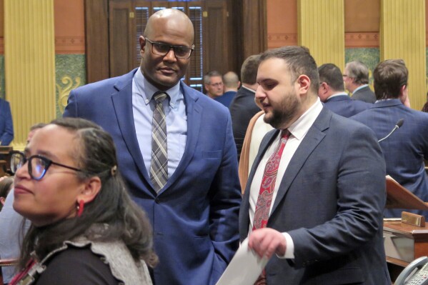 State Rep. Alabas Farhat, right, D-Dearborn, speaks with House Speaker Joe Tate on the Michigan House floor, Tuesday, Feb. 6, 2024, in Lansing, Mich. Farhat would later introduce a resolution to condemn an op-ed piece in The Wall Street Journal that called Dearborn “America’s jihad capital". (AP Photo/Joey Cappelletti)