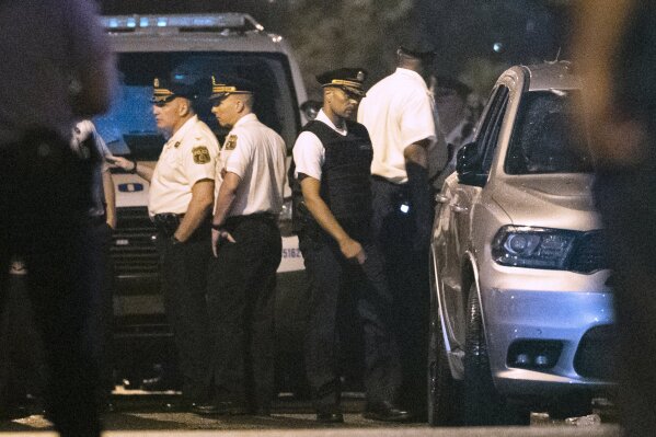 In this Thursday, Aug. 15, 2019 photo Philadelphia Police Commissioner Richard Ross, center right, remains on the scene after a gunman was apprehended following a standoff Philadelphia. The mayor of Philadelphia says on Tuesday, Aug. 20, 2019, that Ross is resigning over new allegations of sexual harassment and racial and gender discrimination against others in the department. Mayor Jim Kenney says that Richard Ross has been a terrific asset to the police department and the city as a whole and that he's disappointed to lose him. (AP Photo/Matt Rourke)